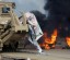 A torn poster of deposed Egyptian President Mursi is pictured as riot police clear the area of his supporters at Rabaa Adawiya square, where the protesters had been camping, in Cairo