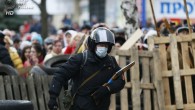 An armed man walks in front of the barricades at the police headquarters in Slaviansk